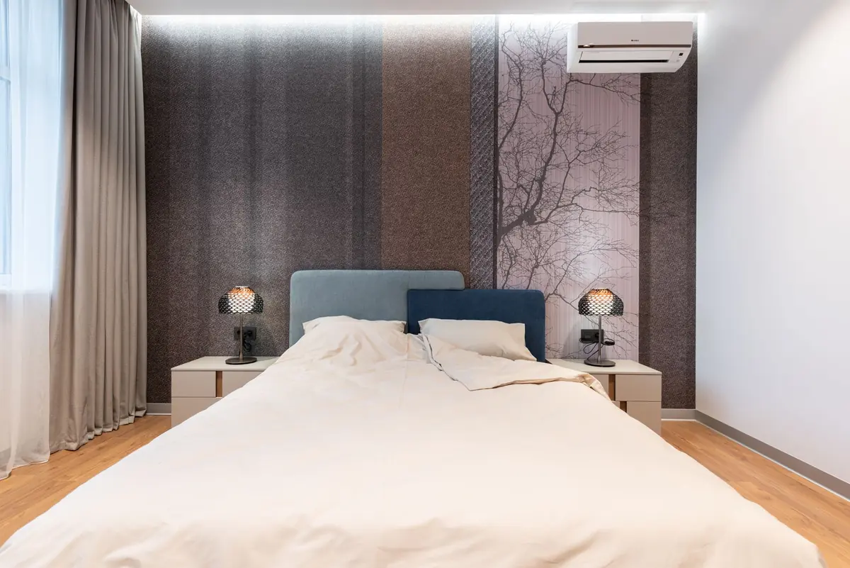 Bedroom with neutral bedding and nightstands, a bed bug treatment focus zone