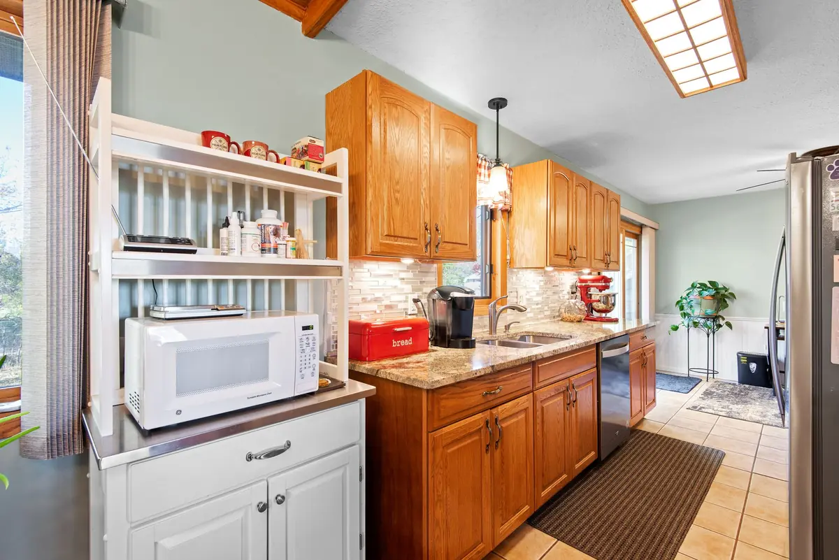 Home kitchen with oak cabinets, a common spot-treatment area between quarterly visits